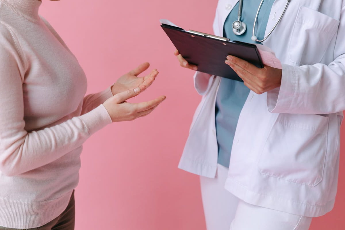 A healthcare professional listening to a patient's concerns during a medical consultation.